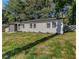 Charming single-story home with a modern gray brick facade, complemented by lush greenery at 1770 Atherton Dr, Decatur, GA 30035