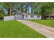Ranch-style home boasts a spacious front yard and a combination driveway for parking at 1770 Atherton Dr, Decatur, GA 30035