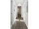 Hallway with laminate floors leading to various rooms at 1770 Atherton Dr, Decatur, GA 30035