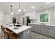 Modern kitchen with stainless appliances, bar seating, and decorative tile backsplash at 1770 Atherton Dr, Decatur, GA 30035