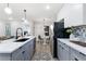 Contemporary kitchen features gray lower cabinets, white upper cabinets, stainless steel appliances, and an open concept layout at 1770 Atherton Dr, Decatur, GA 30035