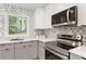 Bright kitchen features stainless steel appliances, white cabinets, and a decorative backsplash at 1770 Atherton Dr, Decatur, GA 30035