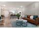 Open-concept living room and kitchen area with modern furniture and stainless steel appliances at 1770 Atherton Dr, Decatur, GA 30035