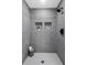Walk-in shower features sleek gray tiles and modern fixtures at 1770 Atherton Dr, Decatur, GA 30035