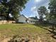 Spacious backyard with lush green lawn, garden beds, and privacy fence at 2303 Condor Dr, Lawrenceville, GA 30044