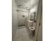 Modern bathroom with a glass-enclosed shower, sleek vanity, and stylish marble-like tile throughout at 2303 Condor Dr, Lawrenceville, GA 30044