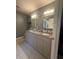 Bathroom features double vanity with granite countertop, updated tile flooring, and neutral walls at 2303 Condor Dr, Lawrenceville, GA 30044