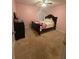 Bedroom featuring soft pink paint, plush carpet, dresser, and natural light at 2303 Condor Dr, Lawrenceville, GA 30044