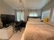 Comfortable bedroom featuring natural light, a plush bed, and a dedicated workspace with a modern desk at 2303 Condor Dr, Lawrenceville, GA 30044