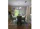 Cozy dining room featuring chandelier, rug, and natural light from glass sliding doors at 2303 Condor Dr, Lawrenceville, GA 30044
