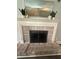 Close-up of a brick fireplace with a decorative mantle and hearth at 2303 Condor Dr, Lawrenceville, GA 30044