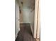 Hallway leading to rooms with modern light fixture and neutral walls at 2303 Condor Dr, Lawrenceville, GA 30044