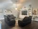 Cozy living room with a fireplace, media center, and comfortable furnishings at 2303 Condor Dr, Lawrenceville, GA 30044
