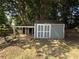 Backyard shed with adjacent covered patio, providing storage and outdoor space at 2303 Condor Dr, Lawrenceville, GA 30044