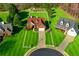 Beautiful aerial view of a red brick home with manicured lawn and long driveway on a large lot at 3076 Harris Mill Ct, Duluth, GA 30096