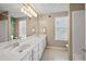 Bright bathroom featuring double sinks, a large mirror, and plenty of counter space at 3076 Harris Mill Ct, Duluth, GA 30096