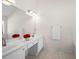 Clean, all-white bathroom boasts double sinks, a large mirror, and bright lighting at 3076 Harris Mill Ct, Duluth, GA 30096