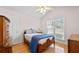 Cozy bedroom with hardwood floors, natural light, and a ceiling fan at 3076 Harris Mill Ct, Duluth, GA 30096