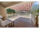 Relaxing outdoor deck with retractable awning, white railings, and comfortable patio furniture at 3076 Harris Mill Ct, Duluth, GA 30096