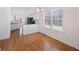 Open-concept kitchen and dining area with white cabinets and stainless steel appliances at 3076 Harris Mill Ct, Duluth, GA 30096