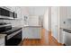 Bright kitchen features white cabinets, stainless steel appliances, and granite countertops at 3076 Harris Mill Ct, Duluth, GA 30096