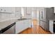 Modern kitchen features stainless steel appliances, granite countertops, and hardwood floors at 3076 Harris Mill Ct, Duluth, GA 30096
