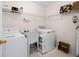 Functional laundry room with washer, dryer, sink, and storage shelves at 3076 Harris Mill Ct, Duluth, GA 30096