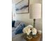 Close-up of a cozy living room with a modern lamp, flowers, throw pillows, and neutral colors at 3076 Harris Mill Ct, Duluth, GA 30096