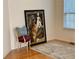 Cozy living space featuring hardwood floors, an accent chair, rug, and a colorful framed painting at 3076 Harris Mill Ct, Duluth, GA 30096