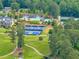Aerial view showcasing community amenities, including a pool, tennis courts, golf course, and clubhouse at 3459 Clubland Dr, Marietta, GA 30068