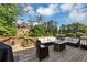 Relaxing back deck with cushioned outdoor furniture and modern gas fire pit offers perfect entertaining space at 3459 Clubland Dr, Marietta, GA 30068