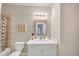 Modern bathroom with light vanity, large mirror, decorative lighting, and tub with shower curtain at 3459 Clubland Dr, Marietta, GA 30068