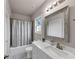 Bathroom features a white vanity, framed mirror, shower with patterned curtain, and a window at 3459 Clubland Dr, Marietta, GA 30068
