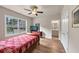 Cozy bedroom features hardwood floors, a window with neighborhood views, and a doorway to the bathroom at 3459 Clubland Dr, Marietta, GA 30068