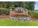 Stone community sign with lush landscaping and flowerbeds, welcoming residents and visitors at 3459 Clubland Dr, Marietta, GA 30068