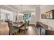 Dining room with hardwood floors, large window, stylish chandelier, and modern buffet at 3459 Clubland Dr, Marietta, GA 30068