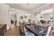 Formal dining room with hardwood floors, contemporary light fixture, and entryways to adjacent rooms at 3459 Clubland Dr, Marietta, GA 30068