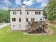 Back exterior view of home featuring an outdoor entertainment area with a fire pit and mature trees at 3459 Clubland Dr, Marietta, GA 30068