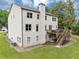 Exterior view showcasing a brick home with a large deck and staircase leading to the backyard at 3459 Clubland Dr, Marietta, GA 30068
