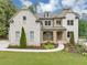 Beautiful two-story brick home with a manicured lawn and stone porch at 3459 Clubland Dr, Marietta, GA 30068