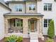 Charming stone-covered front porch with seating area and wooden front door at 3459 Clubland Dr, Marietta, GA 30068