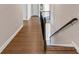 Upstairs hallway features hardwood floors and a staircase with decorative railing at 3459 Clubland Dr, Marietta, GA 30068