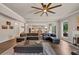Bright living room featuring a large sectional, modern ceiling fan, and open layout to the kitchen at 3459 Clubland Dr, Marietta, GA 30068