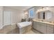 Spa-like main bathroom featuring a jetted tub, double vanities, and modern fixtures, perfect for relaxation at 3459 Clubland Dr, Marietta, GA 30068