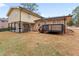 Exterior of home with large patio, brick accents and stairs leading to the backyard at 2002 Twin Falls Rd, Decatur, GA 30032