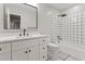 Modern bathroom featuring a marble-top vanity, white tile, and a shower-tub combination at 2002 Twin Falls Rd, Decatur, GA 30032