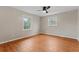 Spacious bedroom with laminate flooring, a ceiling fan, and two windows providing natural light at 2002 Twin Falls Rd, Decatur, GA 30032