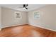 Bright bedroom with neutral walls, laminate flooring, ceiling fan and natural lighting from two windows at 2002 Twin Falls Rd, Decatur, GA 30032
