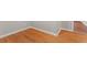 Close up of gleaming hardwood floors with modern white baseboards and entry into another room at 2002 Twin Falls Rd, Decatur, GA 30032