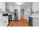 Bright kitchen with white cabinets, stainless steel appliances, tiled backsplash and hardwood floorings at 2002 Twin Falls Rd, Decatur, GA 30032